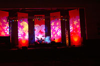 A stage set up for a concert with multi-colored stars and swirls